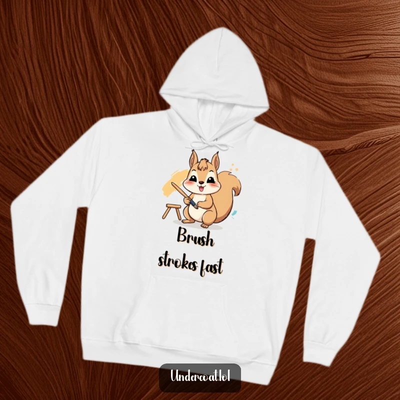 Funny hoodie with a cheerful squirrel actively using a paintbrush to create a vibrant stroke, designed for cozy artistic sessions.